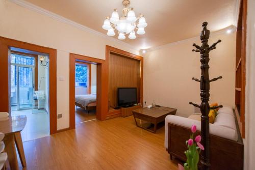 a living room with a couch and a television at Arthur's Roof-Top in Chengdu
