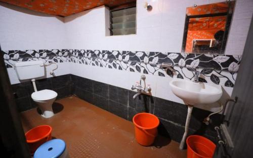a bathroom with a sink and a toilet at Pepper Paradise by StayApart in Dandeli