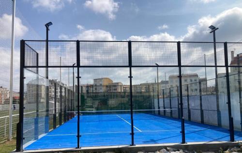 a tennis court in the middle of a city at Top Balea in Pontevedra