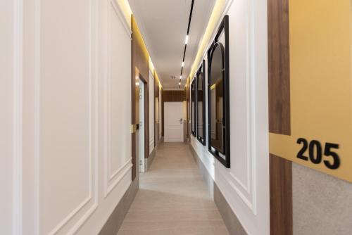 a hallway with white walls and yellow walls at RIVA sleep & chill in Valjevo