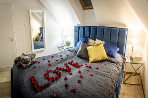 a bed with red hearts on it in a bedroom at Love House Balatonboglár Apartman in Balatonboglár