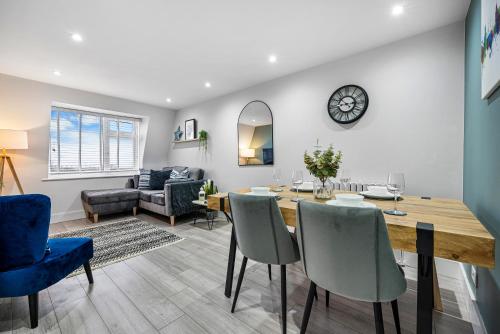 a dining room and living room with a table and chairs at Stunning, Spacious & Cosy 2-Bedroom Southsea Apartment, with Great Panoramic Views, Free Parking Permit, Sleeps 4 SPRING SPECIAL OFFER - by Blue Puffin Stays in Portsmouth