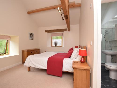 a bedroom with a bed and a bathroom with a sink at 3 bed in Cressbrook 57037 in Cressbrook