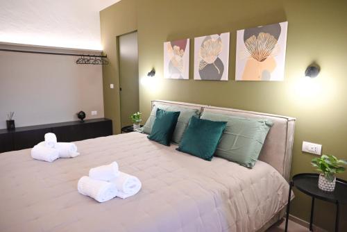 a bedroom with a large bed with towels on it at Dimora Minelli Suites in Monopoli