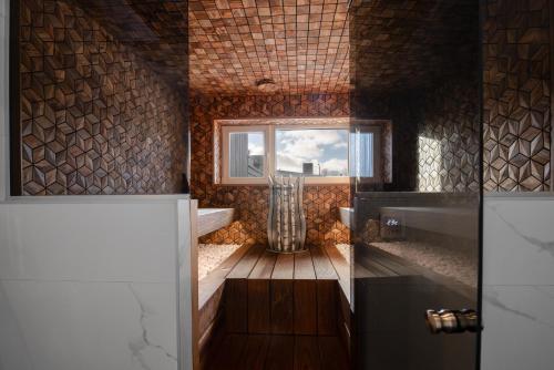 a bathroom with a tub and a window and a sink at Posti villa in Pärnu