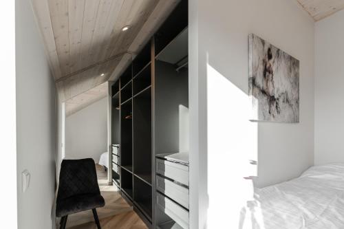 a bedroom with a bed and a desk and a chair at Posti villa in Pärnu