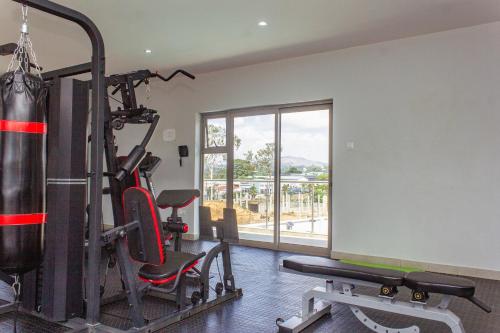 a gym with a punching bag and two tread machines at Cherrywood Estate Limited in Blantyre