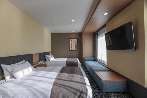 Postel nebo postele na pokoji v ubytování Bayside Hotel Azur Takeshiba