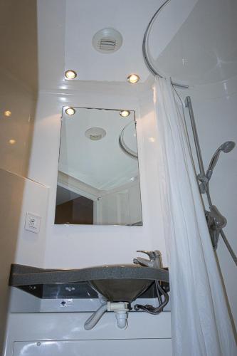 a bathroom with a sink and a mirror at Youth Hostel van Gogh in Brussels