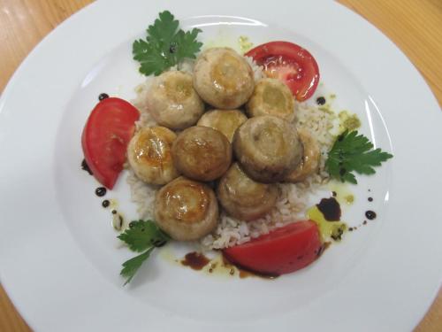 a white plate of food with meatballs and rice at Hotel Novella Uno in Novi Banovci