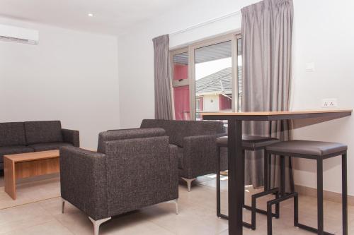 a room with a table and chairs and a window at Cherrywood Estate Limited in Blantyre
