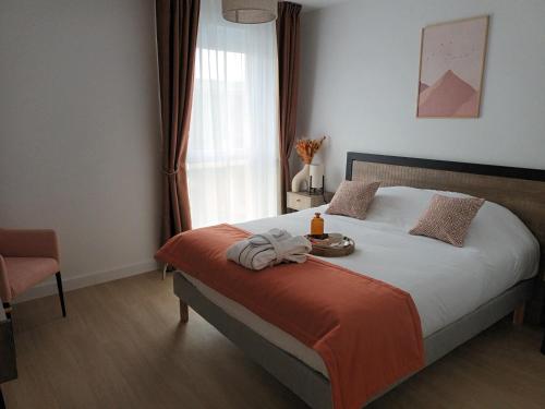 a bedroom with a bed with a tray of food on it at Domitys Les Demoiselles - résidence séniors in Beaune