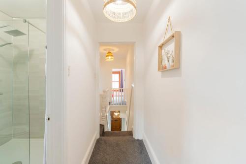 a hallway with a glass shower in a house at The Space by Afan Valley Escapes in Port Talbot