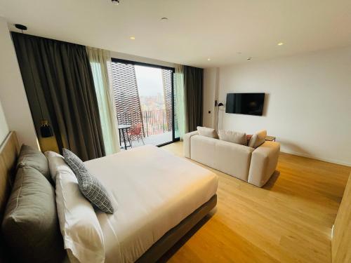 a hotel room with a bed and a couch at Tembo Barcelona in Barcelona