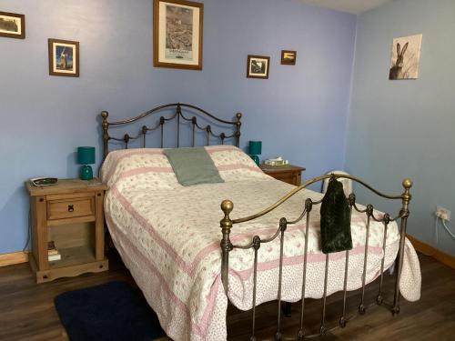 a bedroom with a bed and a table with a night stand at Charming 1-Bed Apartment in Scarning Near Dereham in East Dereham