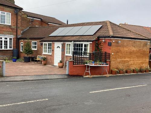 a house with a solar panel on the roof at 1 Bed Free Parking Pets Allowed in East Dereham