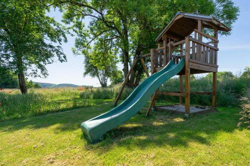 a playground with a slide and a tower at Arduenna Silva ecologic designer house in La-Roche-en-Ardenne