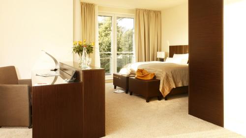 a hotel room with a bed and a window at l'Arrivée Hotel & Spa in Dortmund