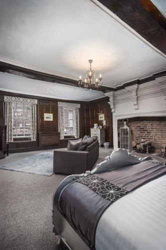 a large bedroom with a bed and a couch at The Pied Bull in Chester