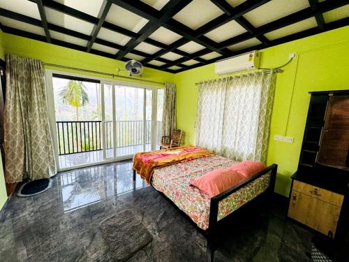 1 dormitorio con 1 cama en una habitación con paredes verdes en Nandhanam Homestay, en Palakkad