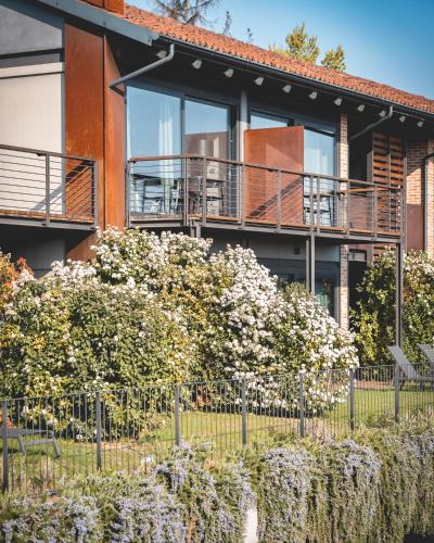 a building with balconies and flowers in front of it at Arborina Relais in La Morra