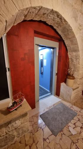 a door in a room with a brick wall at Villa Serenity B&B in Sannat