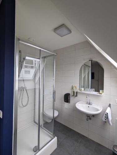 a bathroom with a shower and a sink at 1851 Bar - Hotel - Cinema in Wijk bij Duurstede