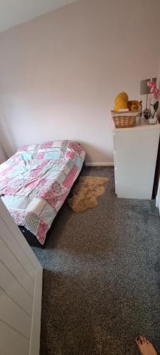 a bedroom with a bed and a white dresser at Comfortable and Convenient in Hatfield