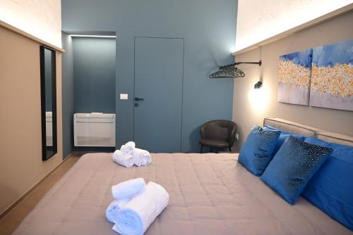 a bedroom with a large bed with towels on it at Dimora Minelli Suites in Monopoli