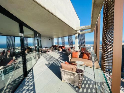 a balcony with chairs and tables on a building at Tembo Barcelona in Barcelona