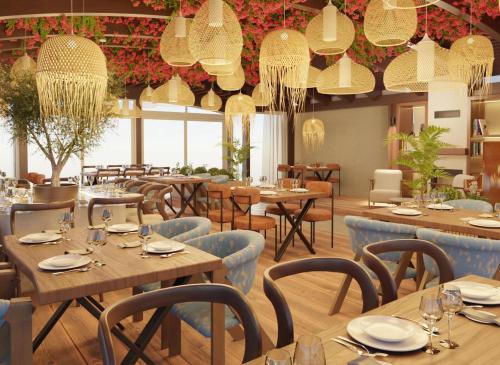 a restaurant with wooden tables and chairs and chandeliers at Luxury Sea Residence by Kristina in Tivat
