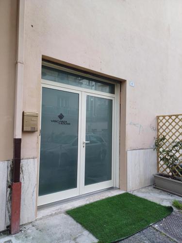 a glass door of a building with a window at Paolessi House in Rieti