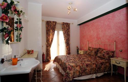 a bedroom with a bed and a tub and a sink at Stalakton Country Maisonettes in Halikounas