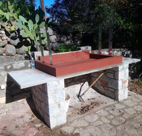 a stone table with a planter on top at Anna's Garden in Triandafilliá