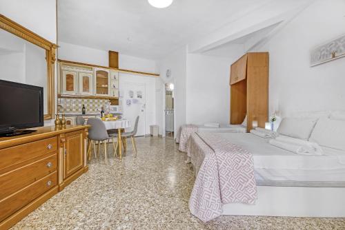 a hotel room with two beds and a television at Benidorm Beach M y G in Benidorm