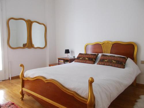 a bedroom with a bed with two mirrors on the wall at Athens Ampelokipoi Penthouse in Athens