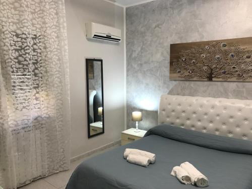 ein Schlafzimmer mit einem Bett mit zwei Handtüchern darauf in der Unterkunft Busalacchi B&B in Mondello