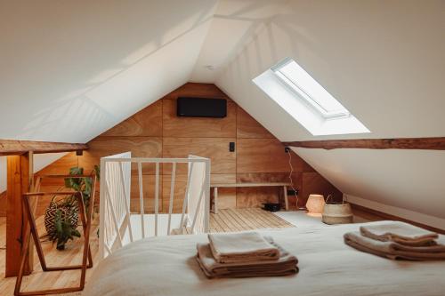 a bedroom with a bed in a attic at Maison Coucou in Thuin