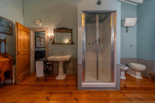a bathroom with a shower and a sink and a toilet at Podere Manafiore in Monticchiello
