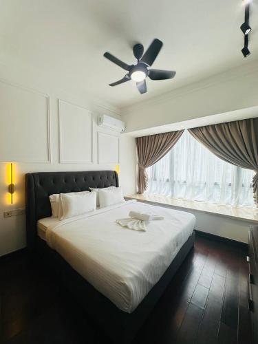 a bedroom with a large bed with a ceiling fan at R&F PRINCESS COVE at ANJU in Johor Bahru