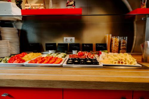 a buffet line with different types of food on display at Ibis Sofia Airport Hotel in Sofia