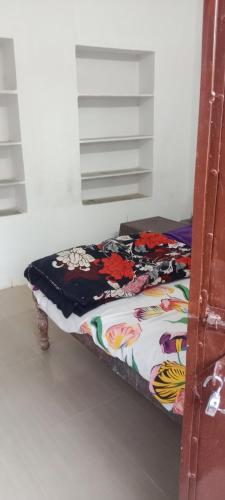 a bed in a room with a blanket on it at Shanti palce hostel in Pushkar
