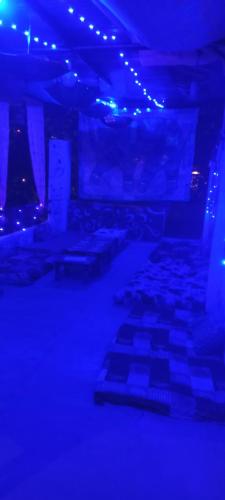 a room with blue lights and a room with keyboards at Shanti palce hostel in Pushkar