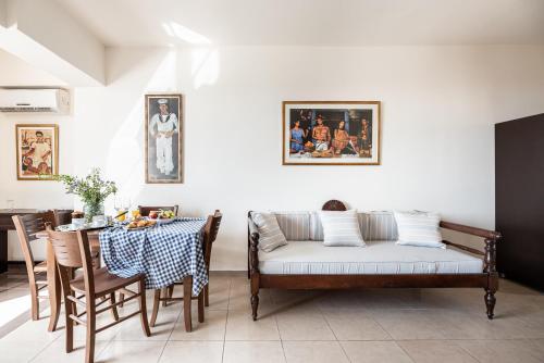 a living room with a couch and a table at Aegean Moments in Glinado Naxos