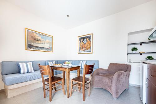 a living room with a table and chairs and a couch at Aegean Moments in Glinado Naxos