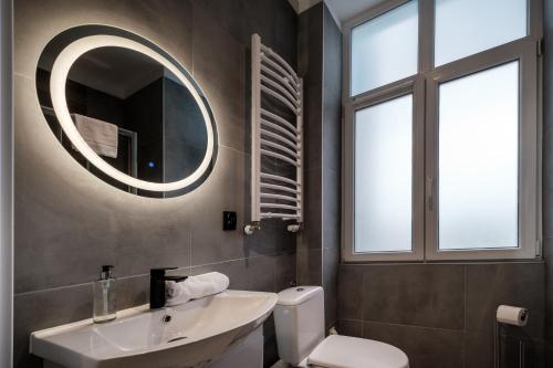 a bathroom with a sink and a mirror on the wall at RentPlanet - Apartamenty Krasińskiego in Wrocław