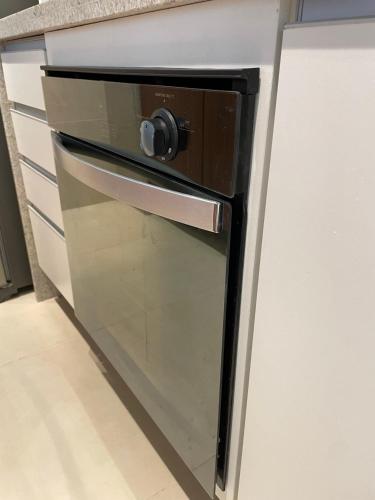 a microwave oven sitting inside of a kitchen at Apto Luxo - Praia dos Carneiros in Praia dos Carneiros