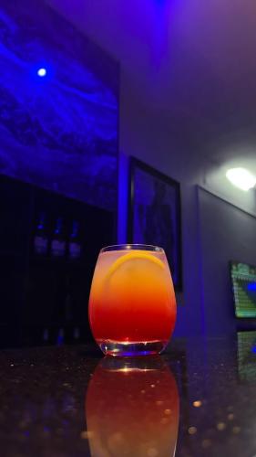 a glass of orange liquid sitting on a table at BLOCK 58 in Lagos