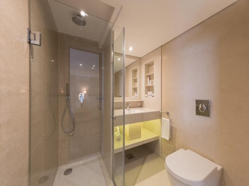 a bathroom with a shower and a toilet and a sink at Steigenberger Regency Nile Cruise - Every Saturday from Luxor for 07 & 04 Nights - Every Wednesday From Aswan for 03 Nights in Luxor