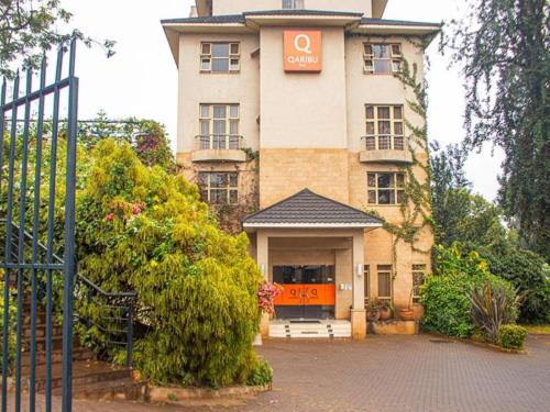 a building with a sign on the front of it at Qaribu Inn Boutique Hotel Nairobi in Nairobi